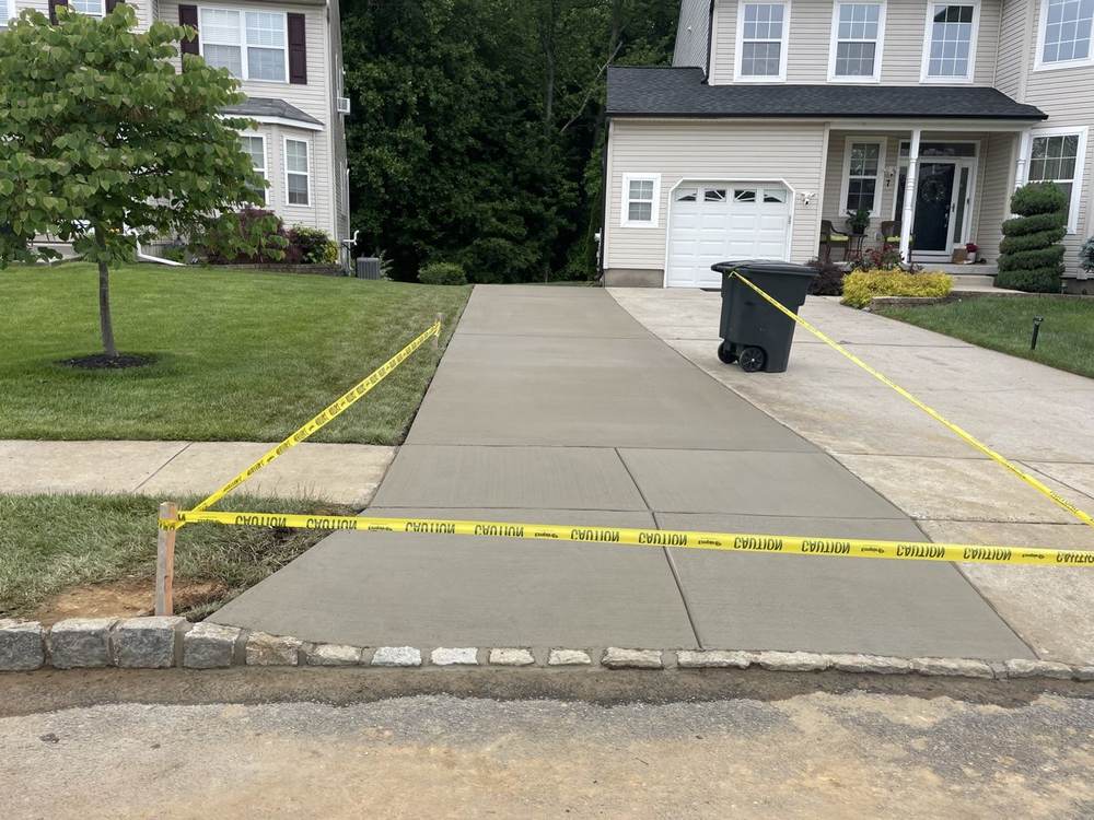 Concrete driveway extension with cobblestone border by South Jersey Construction Enterprise