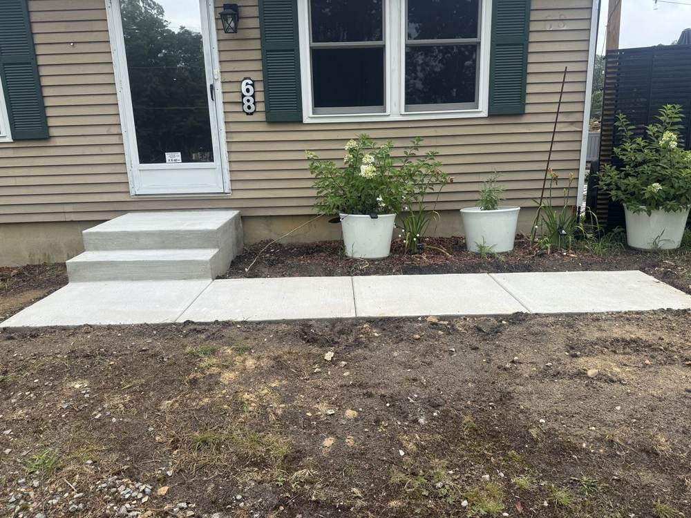 New concrete front walkway with steps to a house entrance by South Jersey Construction Enterprise